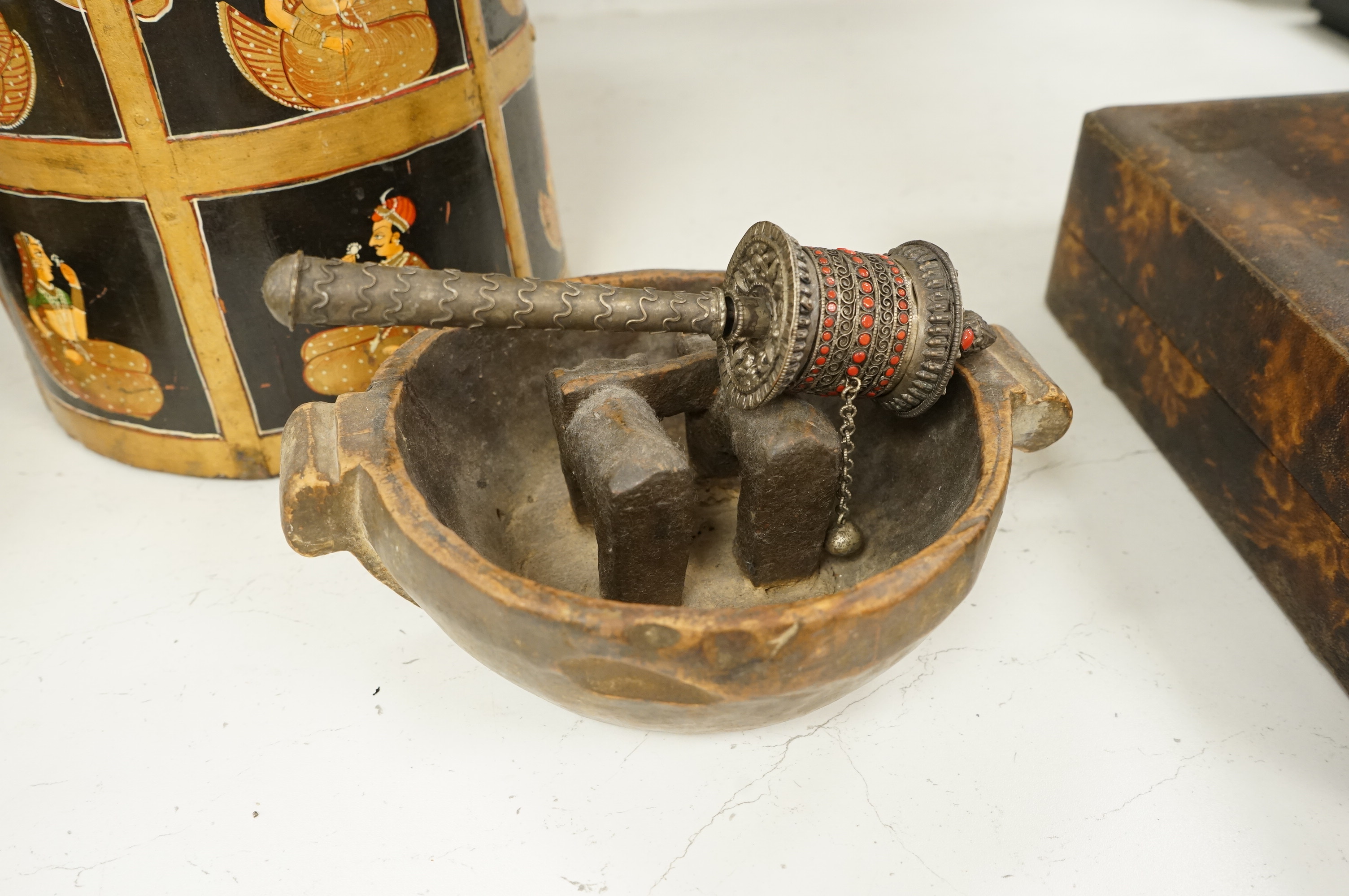 A collection of tribal and Asian collectables including a Tibetan prayer wheel, carvings, etc.